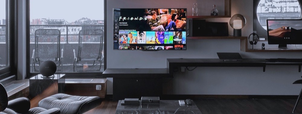 Large wall-mounted screen in a dark lounge