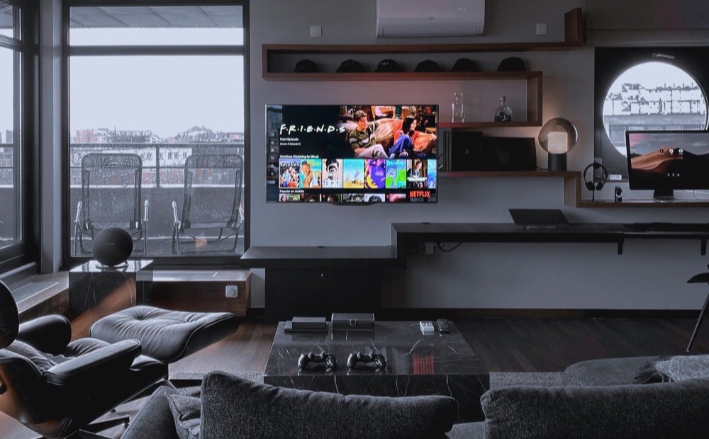 Large wall-mounted screen in a dark lounge