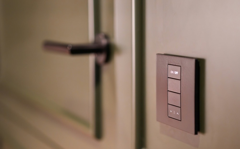 HDL smart lighting keypad mounted beside a door